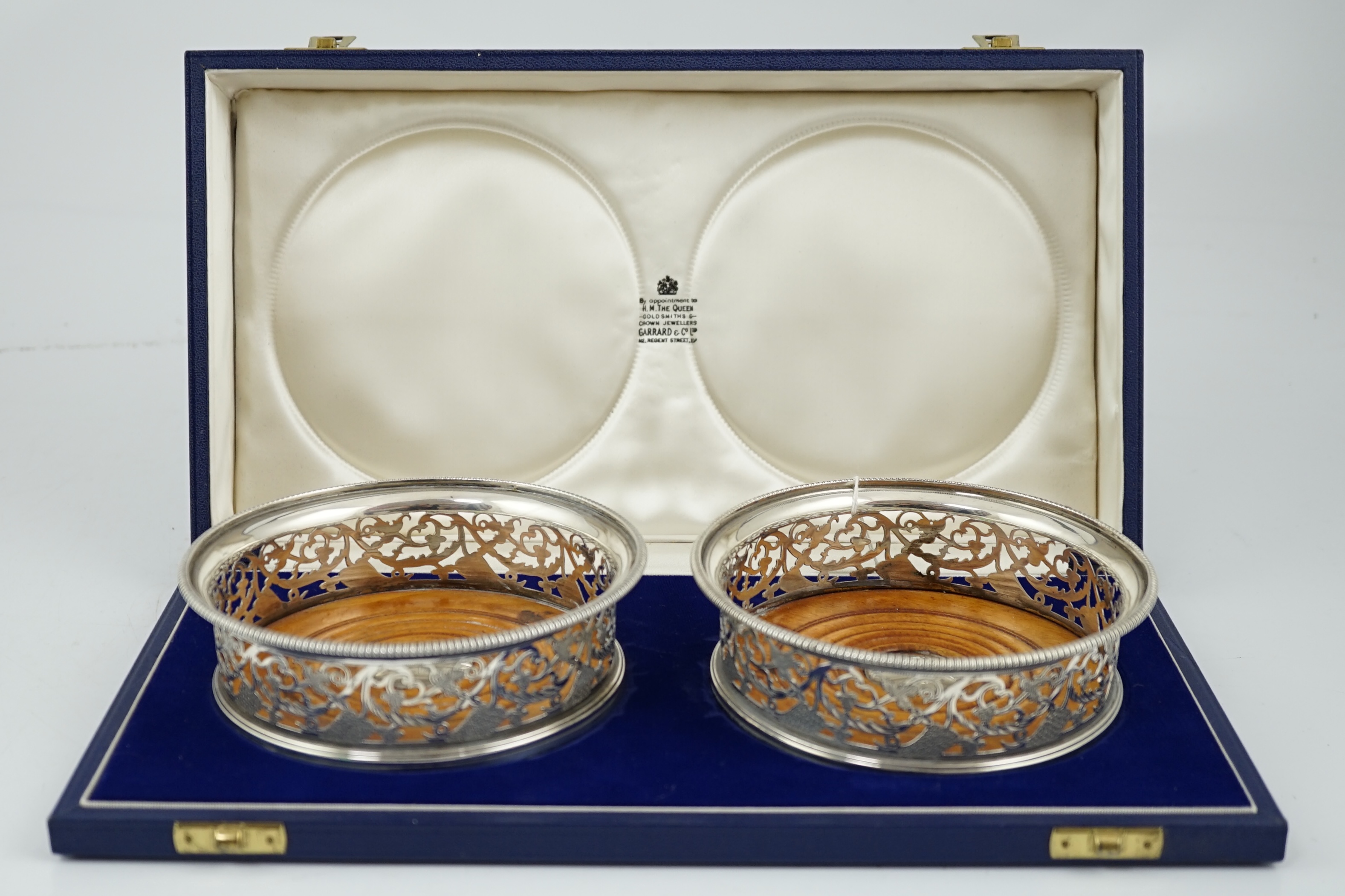 A pair of George III pierced silver mounted wine coasters, William Allen III